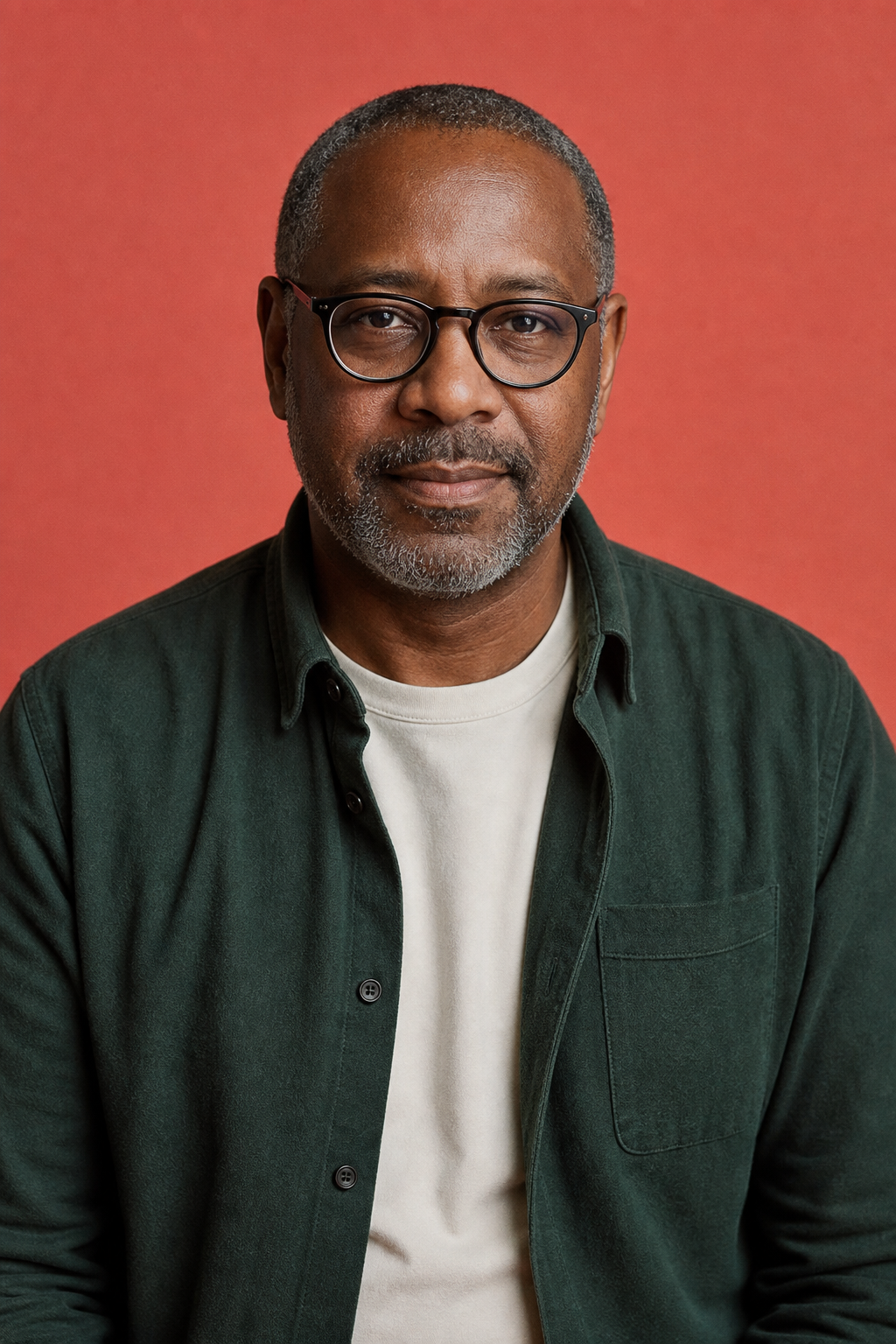 Owen Hartwell, PetPetCat product testing editor, in a forest-green overshirt against a coral background